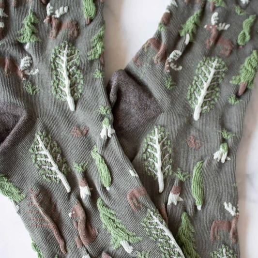 Women's olive crew socks with woodland winter theme of pine trees, moose, bears in olive green with textured, brown, green and brown accents