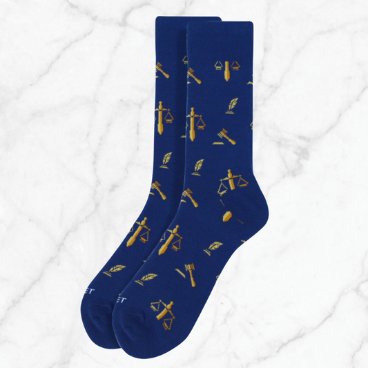 Pair of blue lawyer-themed socks featuring gold scales of justice, quill, and gavel symbols, designed for legal professionals and bar exam candidates.