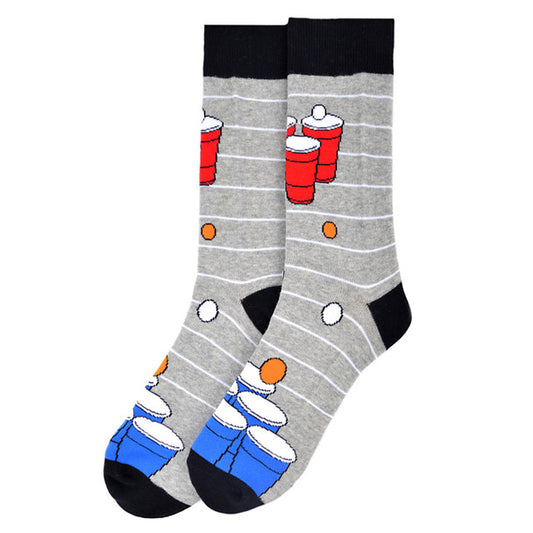 A pair of crew-length socks featuring a playful design with blue and red beer pong cups and white ping pong balls patterned on a grey background with horizontal stripes. The toe, heel, and cuff are solid black, and the socks have a ribbed texture for a snug fit.