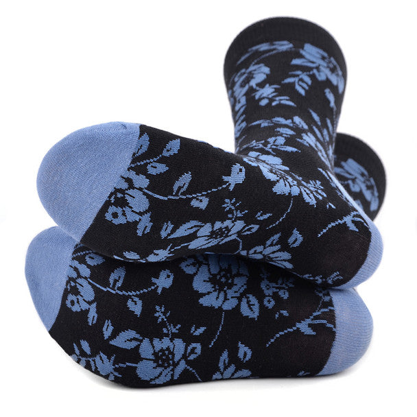 Men's black socks with blue floral and botanical pattern accents, suitable for both garden parties and corporate meetings.