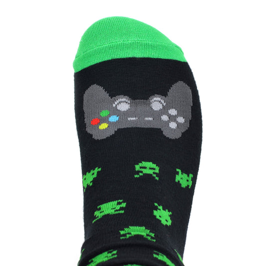 A pair of black crew-length socks with a vibrant green toe, heel, and top trim, featuring an all-over pattern of green pixelated space invaders. The soles of the socks display the phrase "DO NOT DISTURB I AM GAMING" in bold, white capital letters, and the top of the foot showcases a detailed grey gaming controller with colorful buttons. These are signature gaming socks, perfect for the avid gamer. LifeisSocks.com