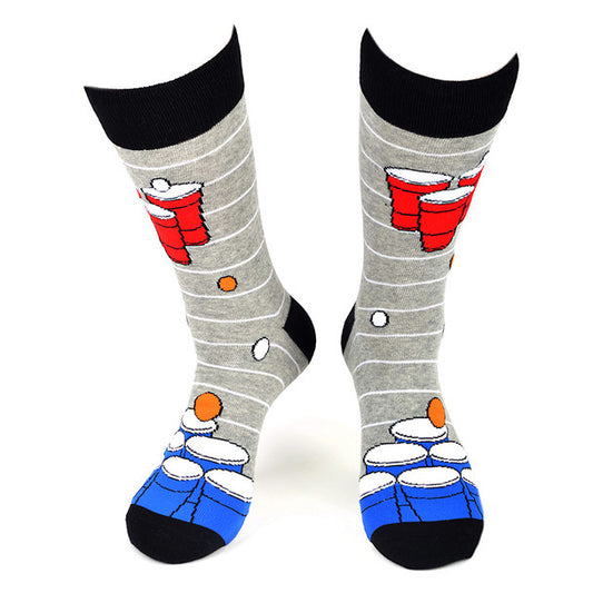 A pair of crew-length socks featuring a playful design with blue and red beer pong cups and white ping pong balls patterned on a grey background with horizontal stripes. The toe, heel, and cuff are solid black, and the socks have a ribbed texture for a snug fit. Life is Socks
