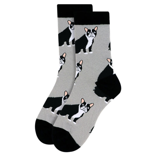   A pair of women's crew socks in a neutral gray shade, featuring multiple French Bulldog faces and silhouettes. The toes and heels are solid black, complementing the playful dog pattern.