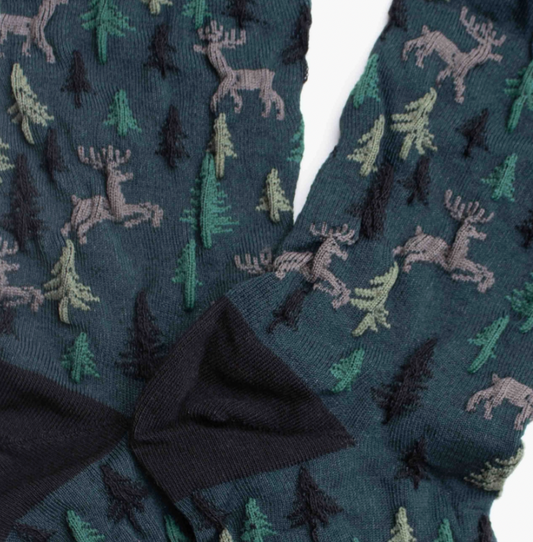 women's holiday forest green socks with deer and pine tree pattern, black heel and toe.