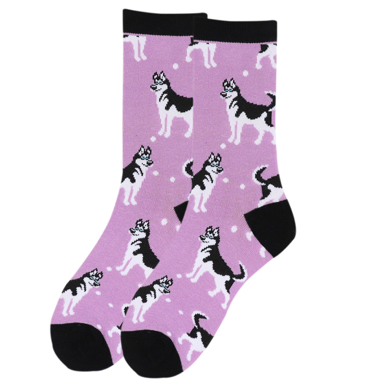 A pair of women's crew socks in a soft lilac color, patterned with black and white Siberian Husky illustrations in various poses, accented with small white dots that suggest a snowy scene. The toe, heel, and cuff of the socks are solid black, providing a contrast to the light purple background.