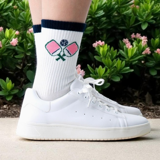 White socks with blue stripe at top and pickleball paddle and ball.