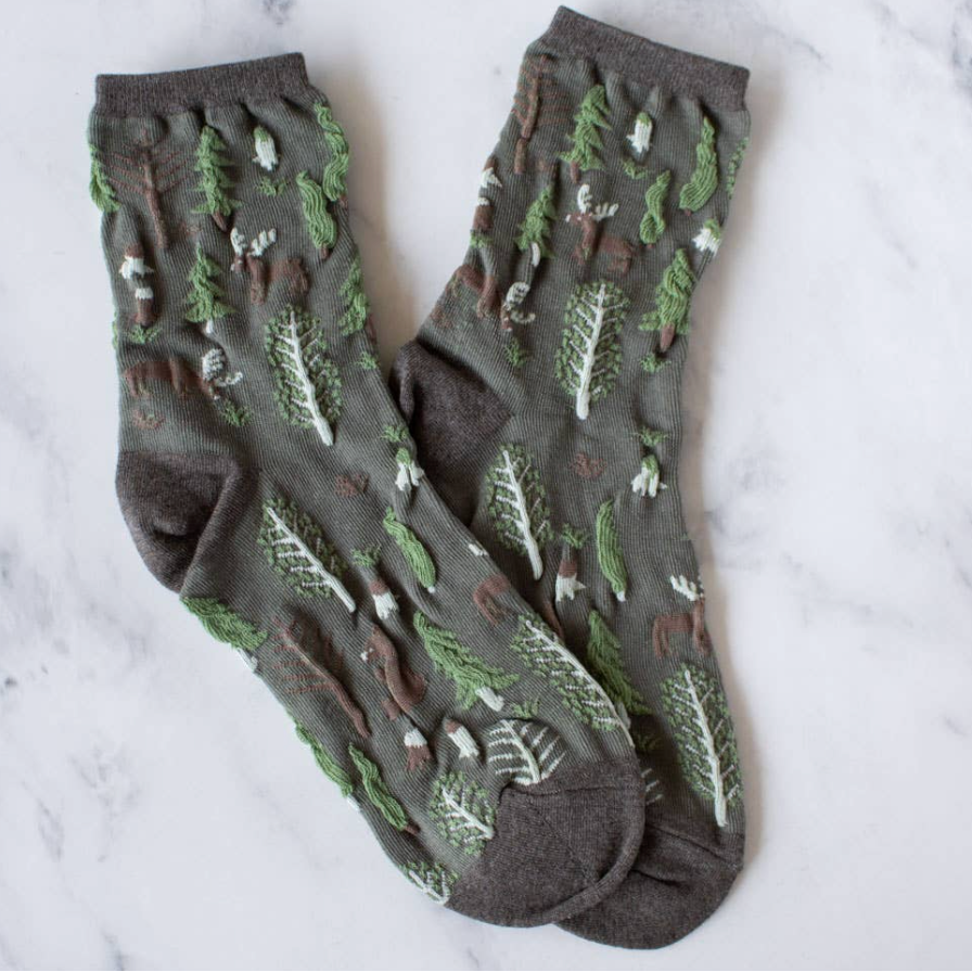 Women's olive crew socks with woodland winter theme of pine trees, moose, bears  in olive green with textured, brown, green and brown accents