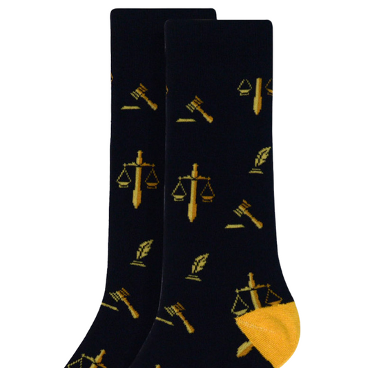 Pair of black lawyer-themed socks featuring gold scales of justice, quill, and gavel symbols, designed for legal professionals and bar exam candidates.