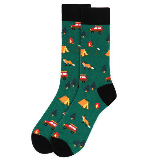 A pair of green camping crew socks with a pattern that includes tents, a fox, and a campfire.